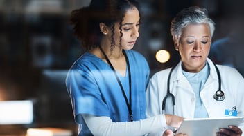 doctor and nurse discussing results on a tablet