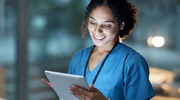 nurse using tablet and smiling