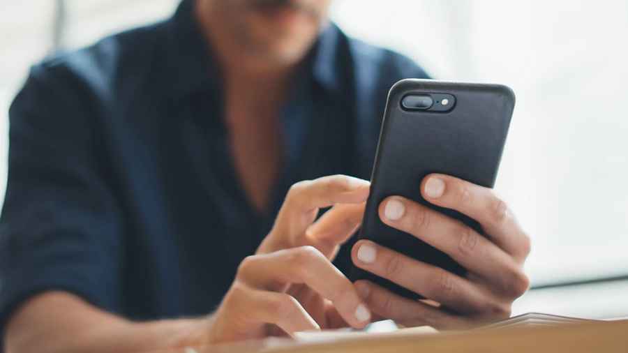 Close-up photo of male hands with smartphone