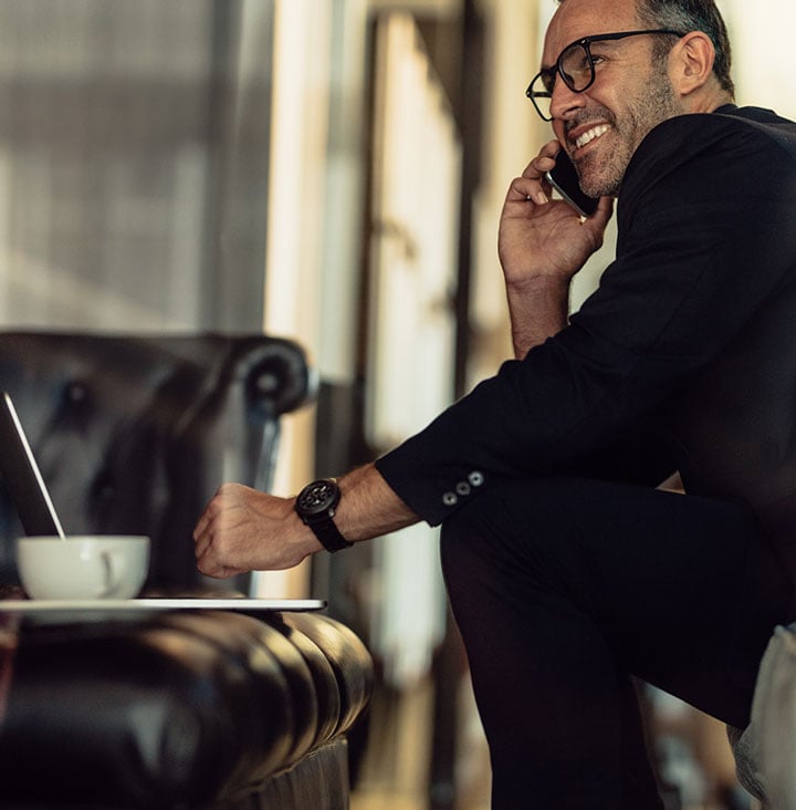 man in hotel lobby on his cell phone