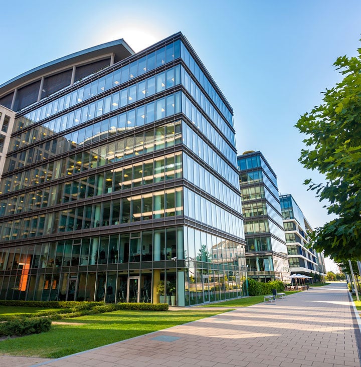 view of large commercial offive from the street on bright sunny day