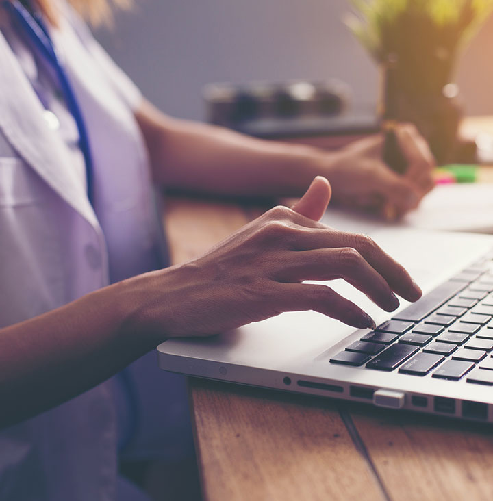 close up view of nurse using laptop